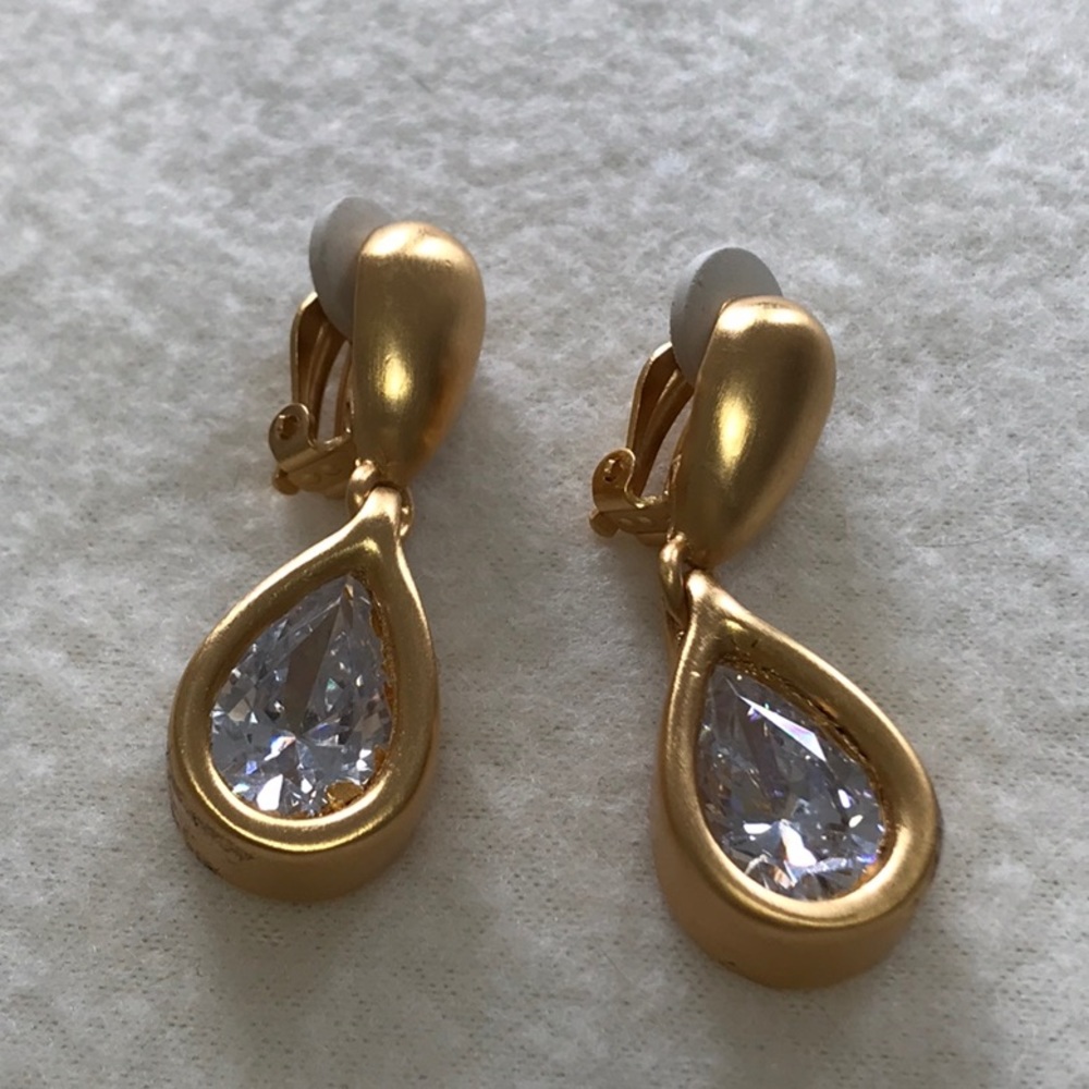 Anne Klein brushed gold tone earrings, clip ons, tear drop shaped center crystal